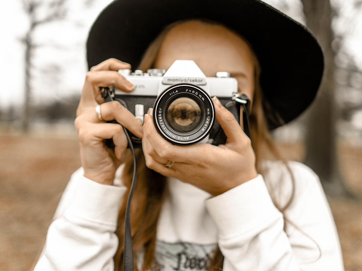 woman holding film camera to her face