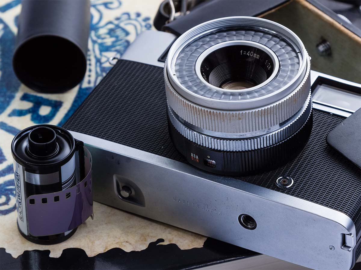 camera next to film canisters